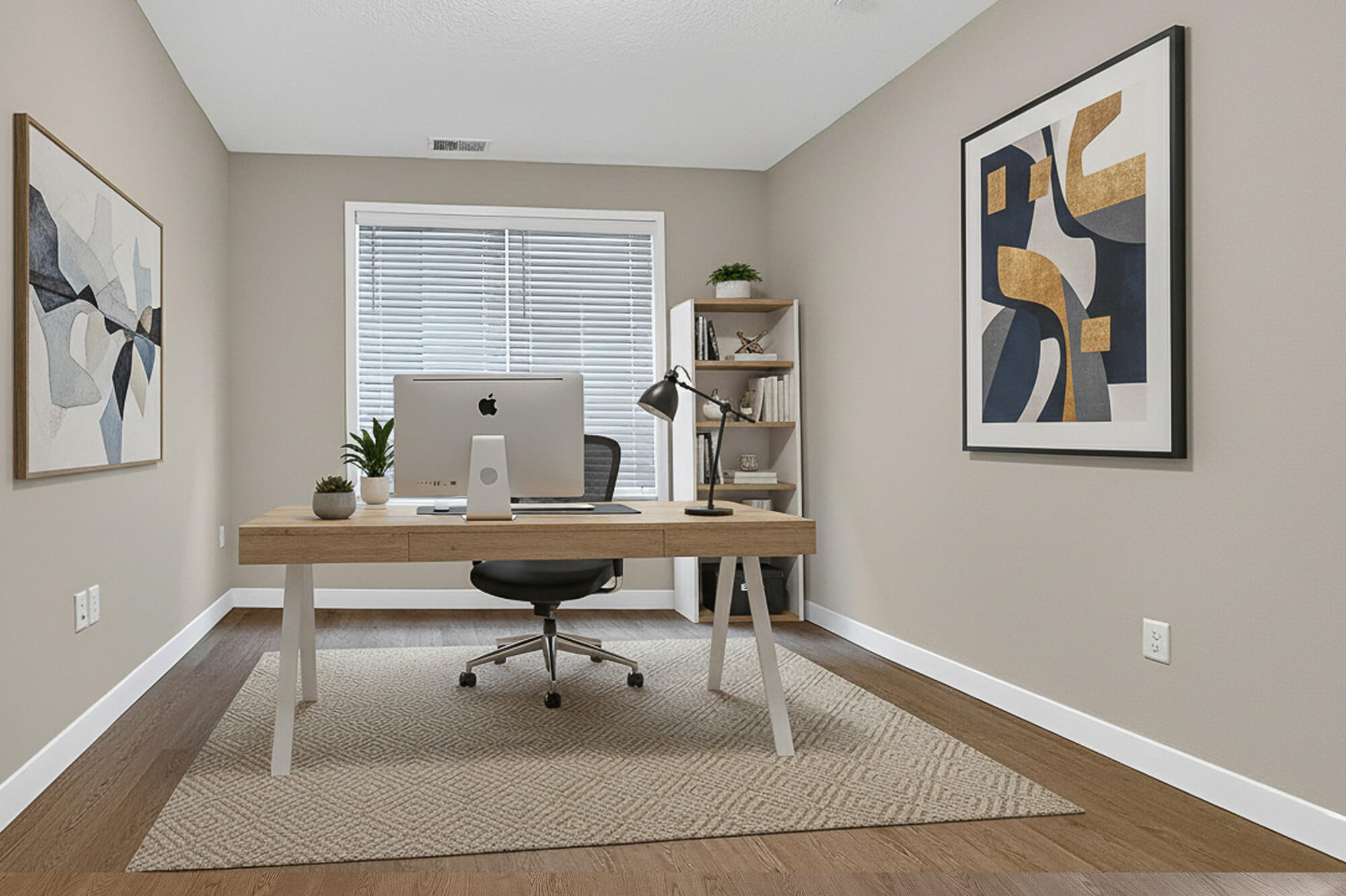 Modern home office with beige walls, wooden desk, and abstract art.